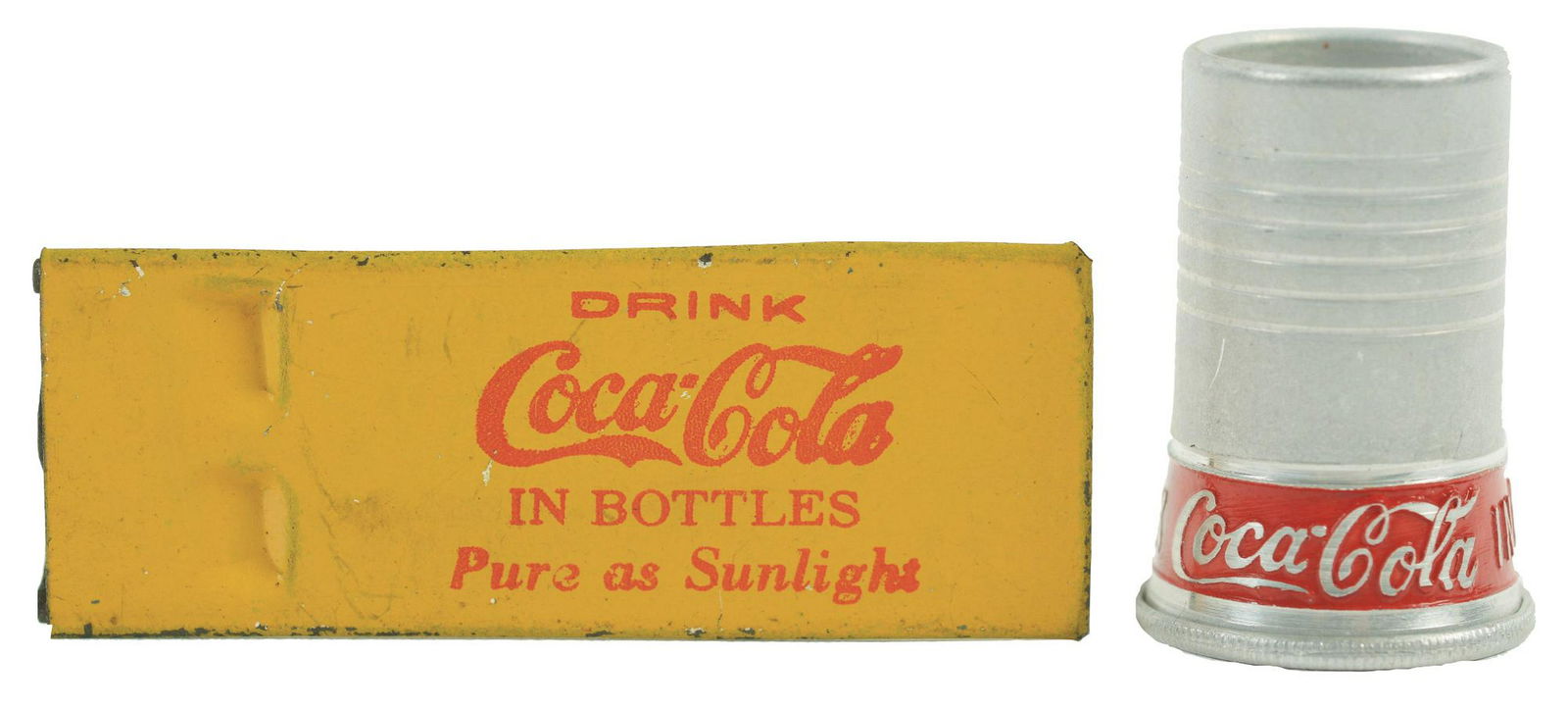 Lot of 2: Coca-Cola Whistles.: 1930s aluminum siren and a 1920s metal whistle. The 1920s whistle has only very light paint wear with good remaining printing, the 1930s siren is very bright with very few marks or wear of any sort. C