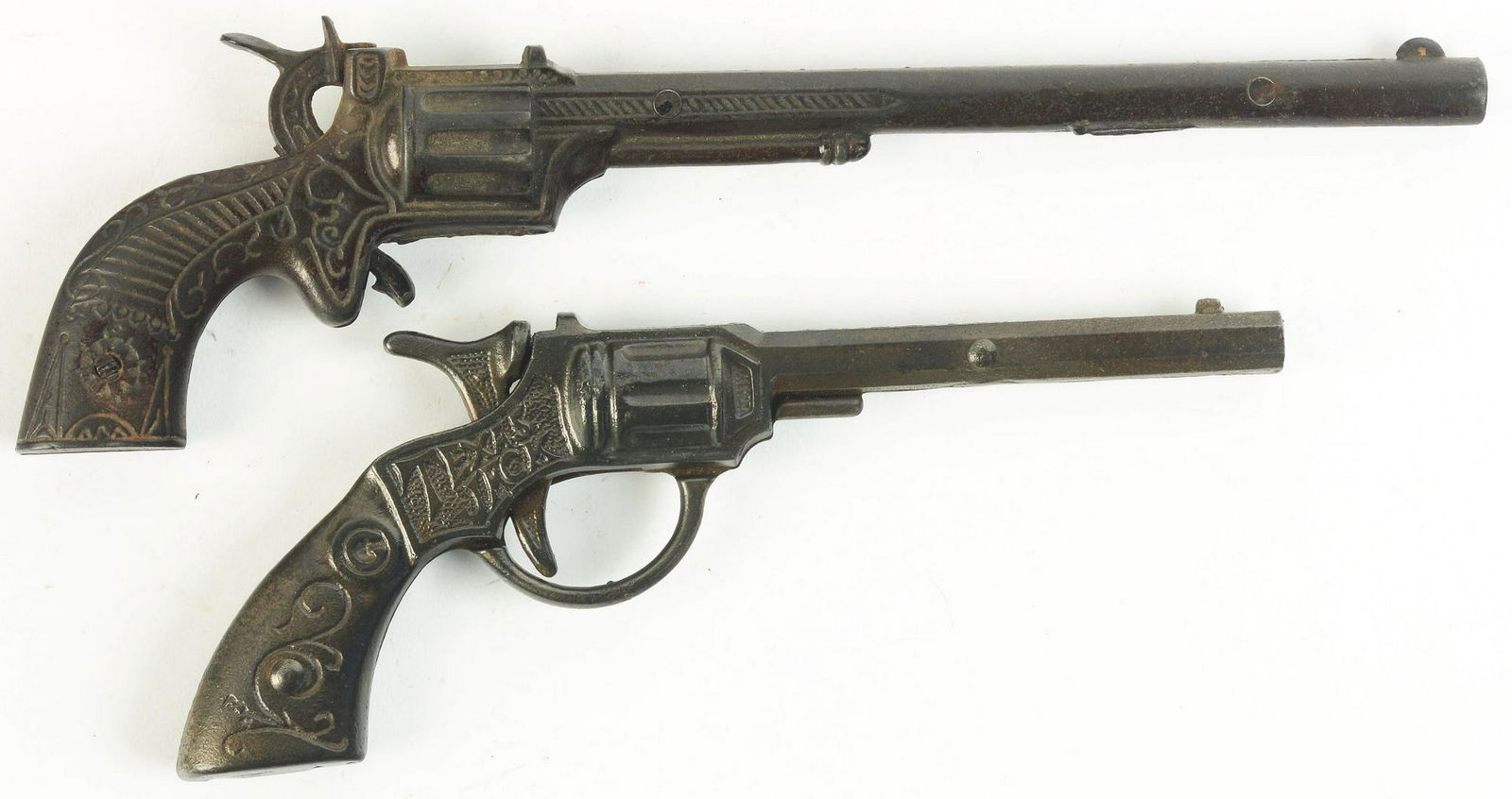 Lot of 2: Rare late 19th Century Cast-Iron Cap Guns.: Circa 1890. One is a Texas Jack, made by Ives; second one is a Buffalo Bill, made by Stevens. Texas Jack is exceedingly rare and is embossed "TEXAS JACK" on both sides above grips. Condition: (Very Go