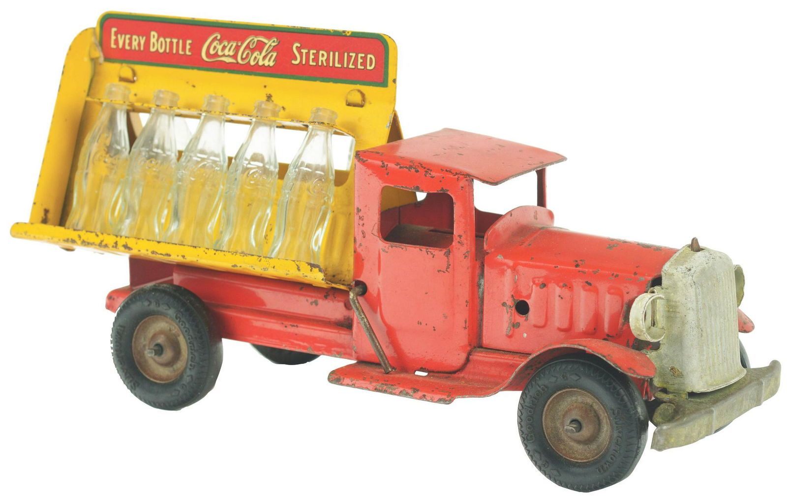 Pressed Steel Metalcraft Coca-Cola Delivery Truck.: Nice decals on back and sides, comes with seven original miniature Coke bottles, has original black ribber tires that say "SILVERTOWN" and also "GOODRICH". Some paint loss and wear throughout. Conditi