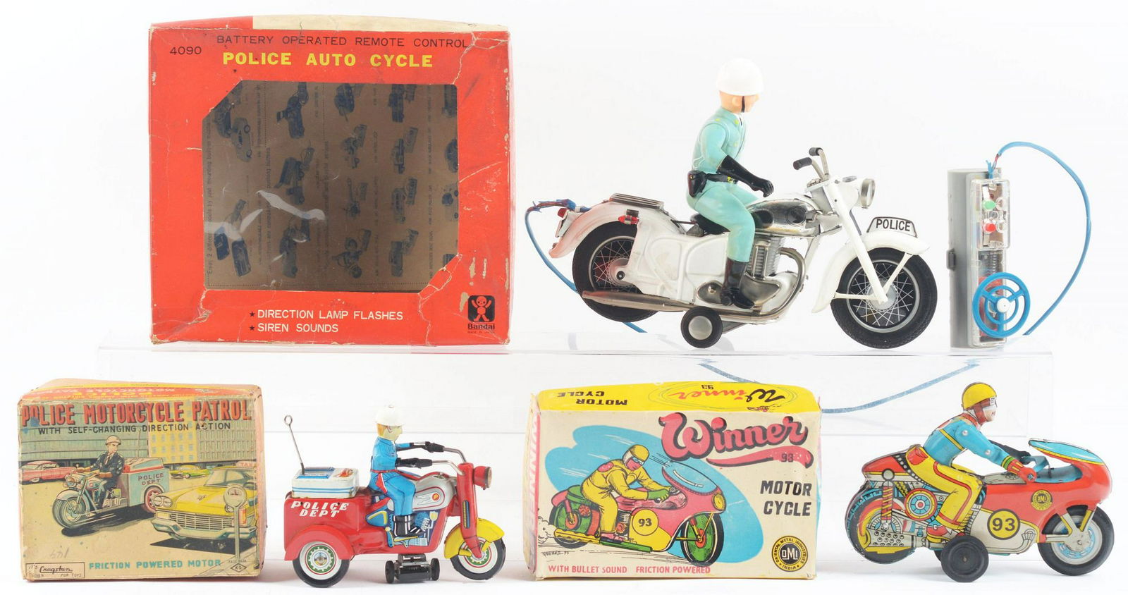 Lot of 3: Japanese and Indian Friction and: All tin-litho with original boxes. Lot consists of: first, a K. O. Police Department three-wheel cycle with crank friction mechanism, box has nice graphics of motorcycle pulling next to a taxi; second