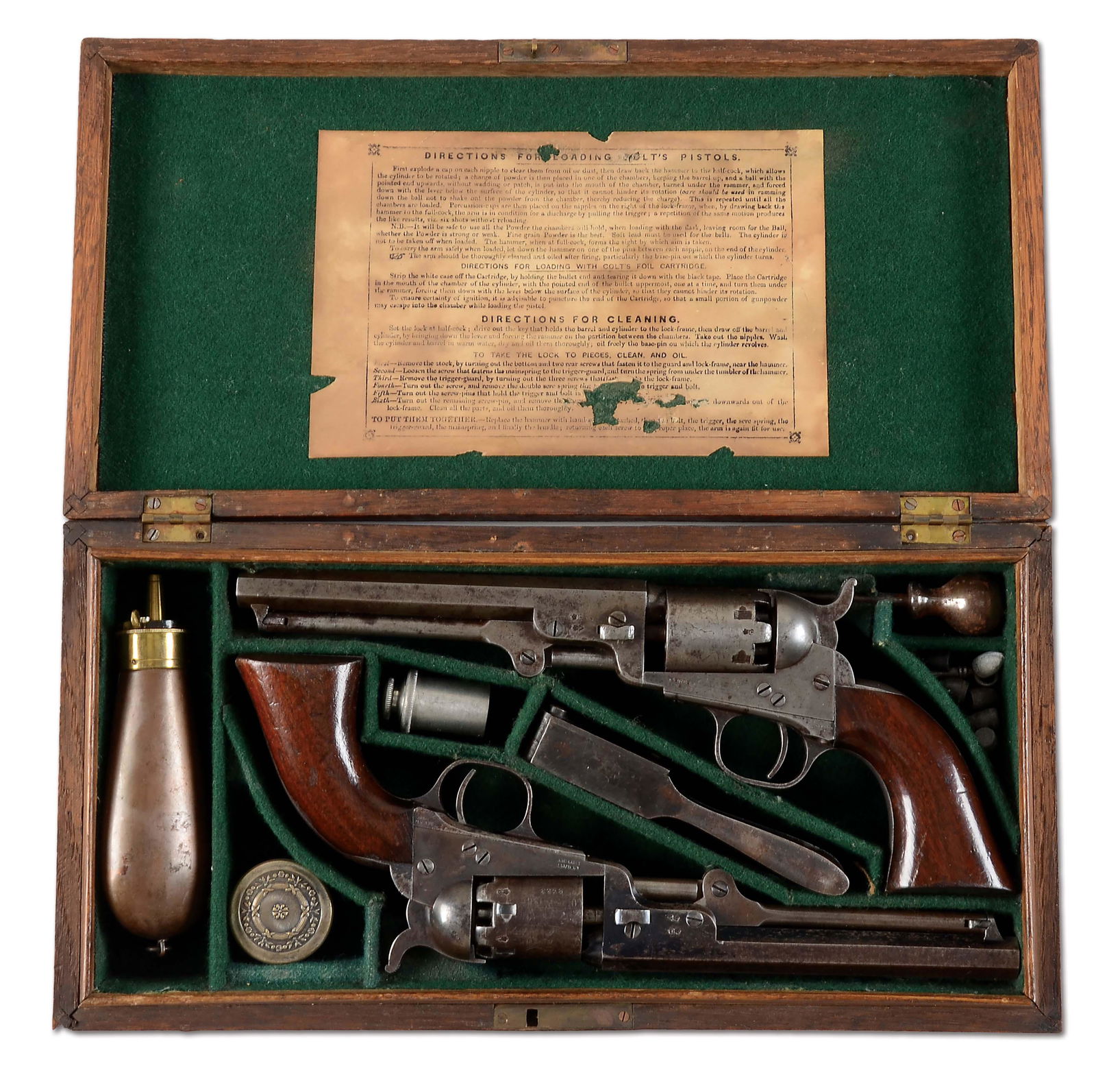 (A) CASED PAIR OF CONSECUTIVE COLT 1849 POCKET: Consecutive serial numbered iron mounted Colt Model 1849 Pocket Model revolvers with 6 inch barrels and housed in London Oak dual case with flask and accessories. Six shot, .31 caliber, with single li