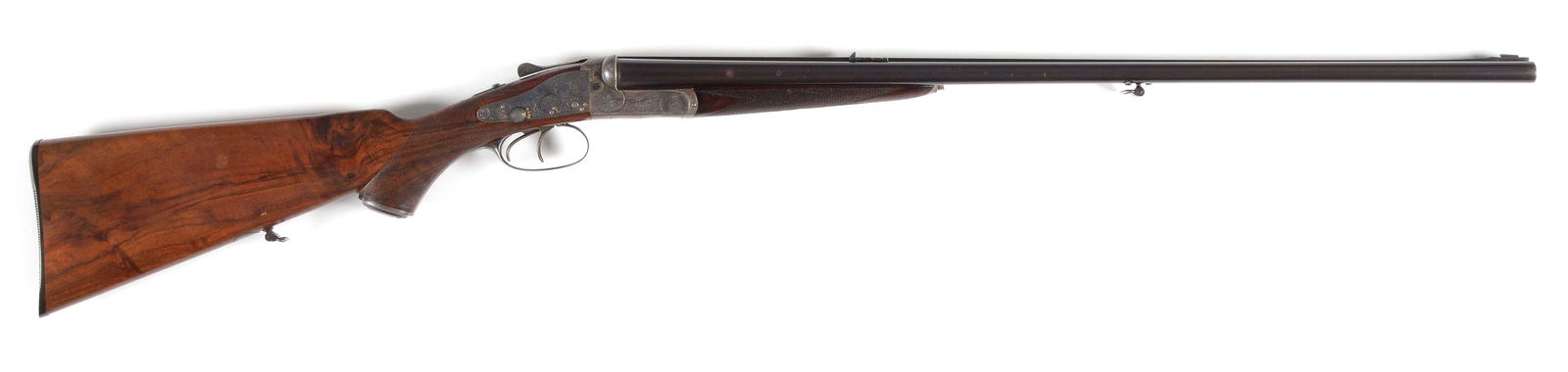 (A) HOLLAND & HOLLAND SIDELOCK DOUBLE RIFLE IN HIGH: (ca 1887) 28" Dovetailed steel barrels are fitted with full length rib which is file cut behind one standing two folding leaf express rear sight, holds silver bead with flip-up night bead in raised fr