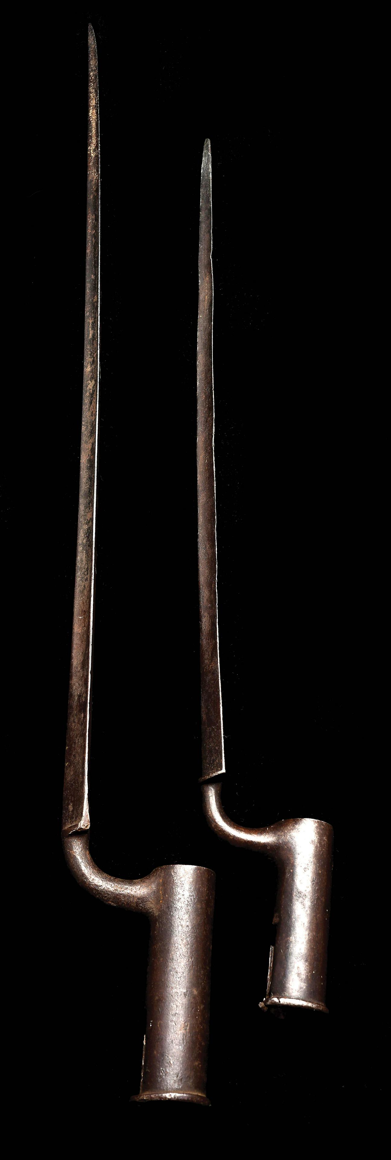 Lot of 2: 18th Century British Socket Bayonets.: Comprising: A) British Fusil or Carbine Bayonet. Opening measures 7/8" and socket measures 3-5/16". Triangular blade unmarked. CONDITION: Retains a dark brown patina with some flattening to tip and sc