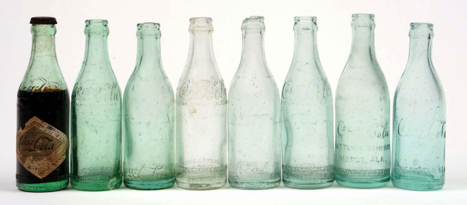 LOT OF 8: ALABAMA COCA-COLA BOTTLES.: Excellent condition. Condition (Excellent). Dimensions Largest: 7 - 3/4" x 2 - 1/4".