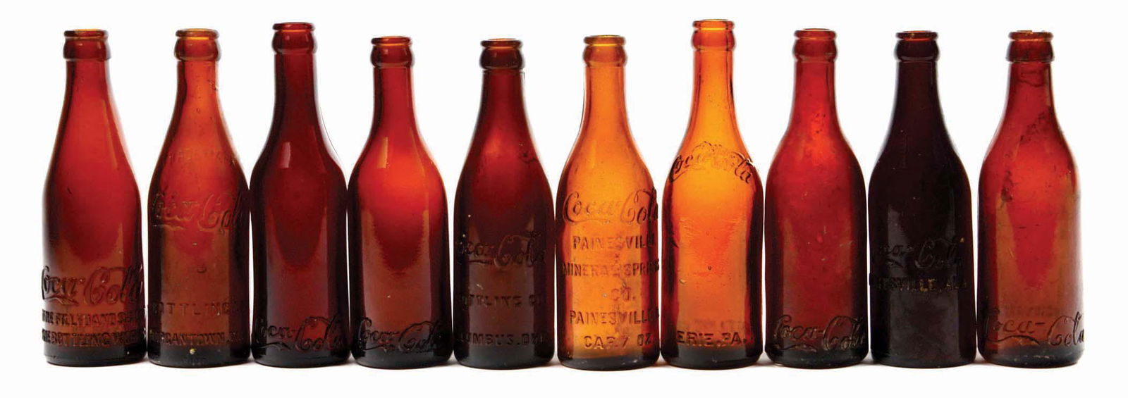 LOT OF 10: AMBER COCA-COLA BOTTLES. (1 of 1)