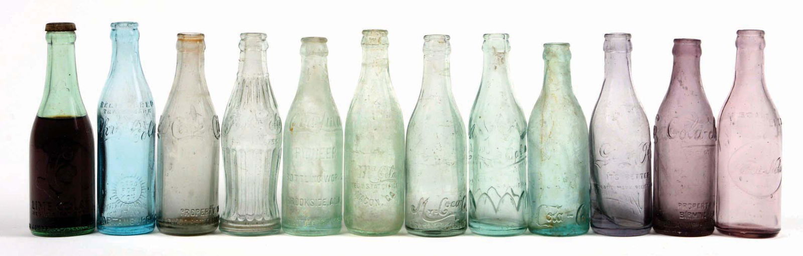 LOT OF 12: MISCELLANEOUS SODA BOTTLES. (1 of 1)
