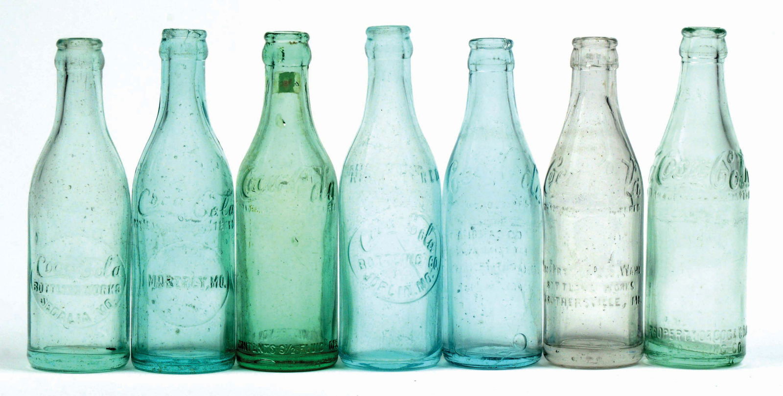 LOT OF 7: MISSOURI COCA-COLA BOTTLES.: Excellent condition. Condition (Excellent). Dimensions Largest: 7 - 3/4" x 2 - 1/4".