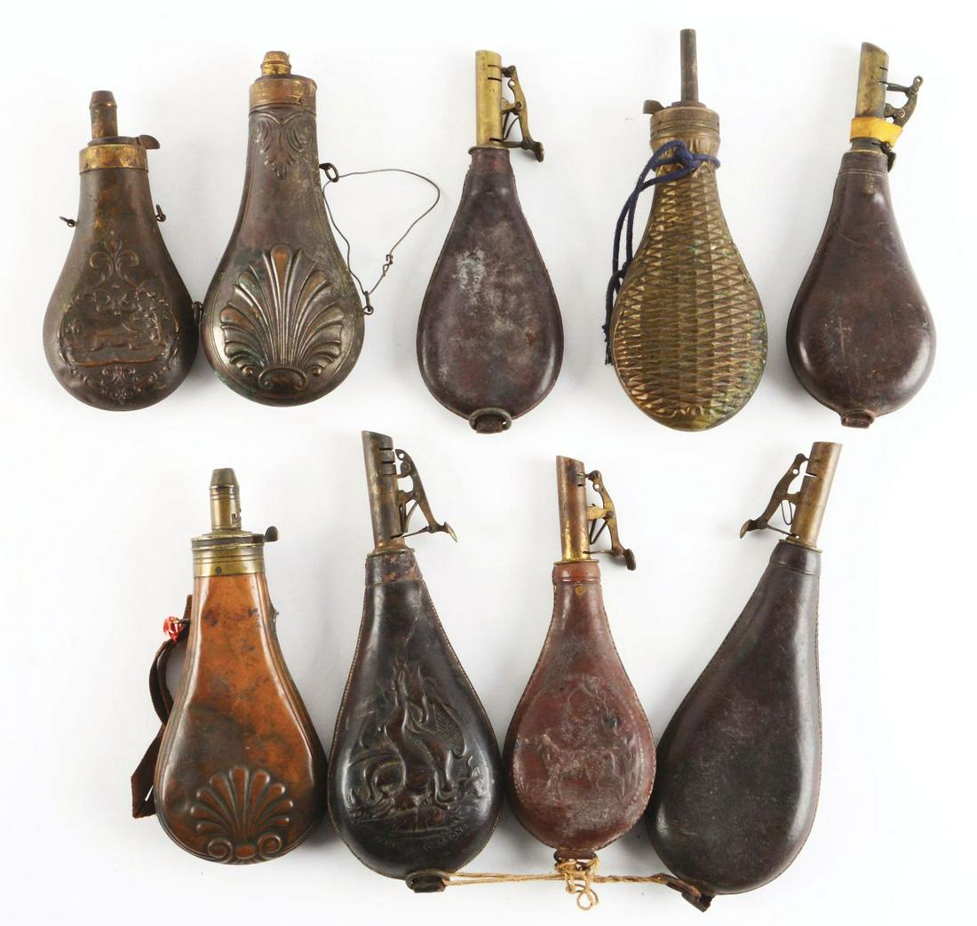 LOT OF 9: POWDER FLASKS AND SHOT BAGS.: Lot consists of assorted powder flasks and shot bags. (A) Leather shot pouch with woodland scene on front. (B) Leather shot pouch. (C) Leather shot pouch. (D) Leather shot pouch with woodland scene on