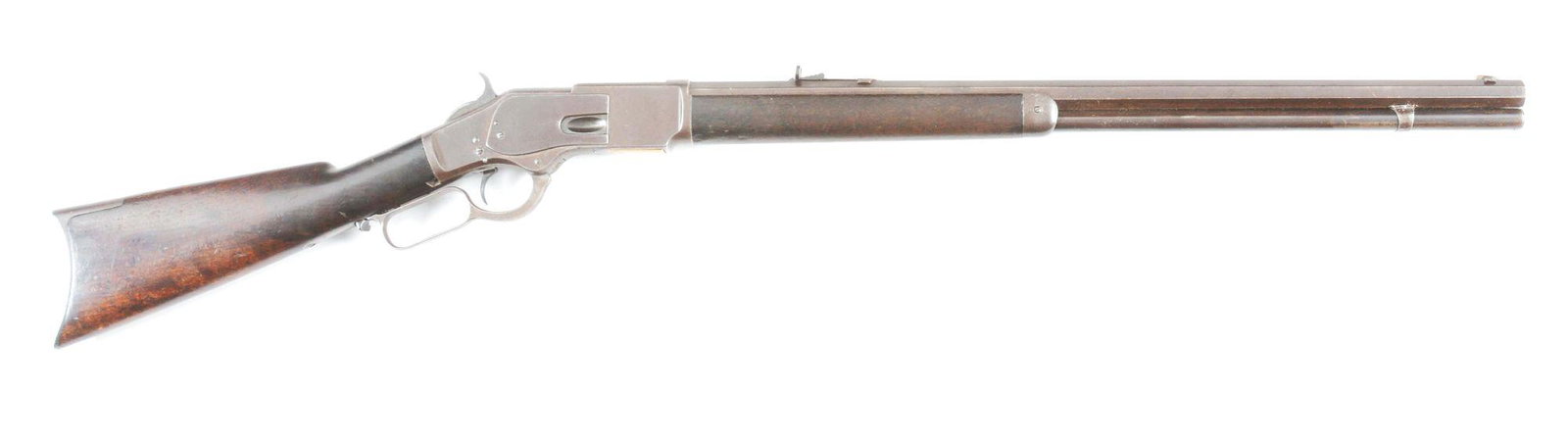 (A) WINCHESTER FIRST MODEL 1873 RIFLE IN .44-40 (1879): Manufactured 1879. Winchester Model 1873 First Model rifle with second pattern checkered thumbprint dust cover. Octagon barrel with full magazine and two piece walnut stocks. Blade front sight with la