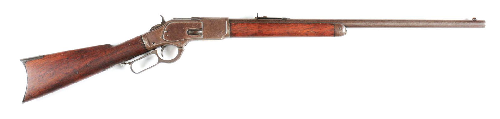 (A) WINCHESTER MODEL 1873 LEVER ACTION RIFLE.: 1884 vintage Model 1873. Full round barrel. Button magazine tube. Plain straight grain walnut stock and forearm. Rifle style crescent buttplate. CONDITION: Very good with overall brown patina. Bore is
