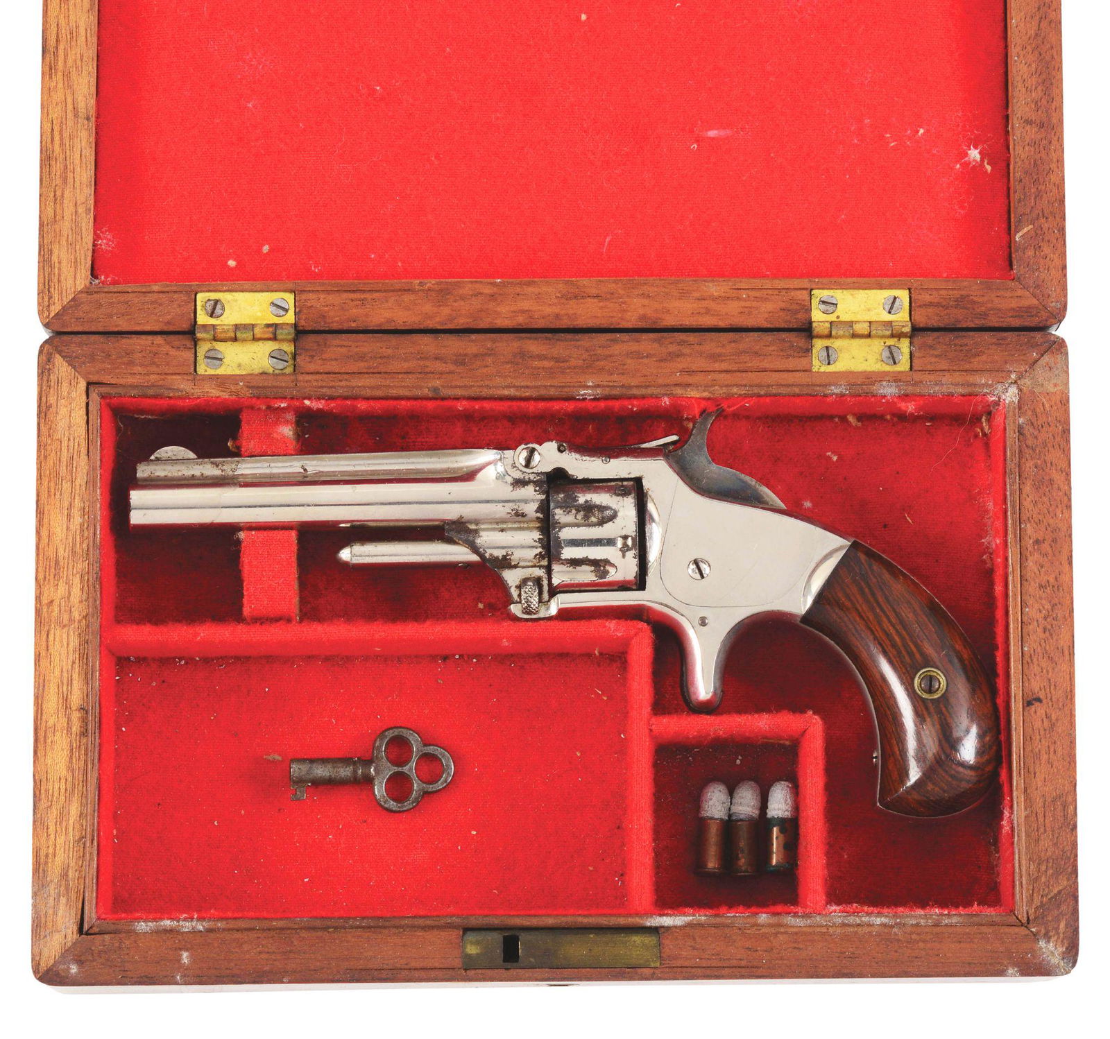 (A) SMITH & WESSON 1-3RD ISSUE REVOLVER.: Smith & Wesson First Model 3rd issue revolver with case. Factory nickel finish. Grip looks to have been re-finished at some point. Case includes three corroded rounds of ammunition and a key. Case is