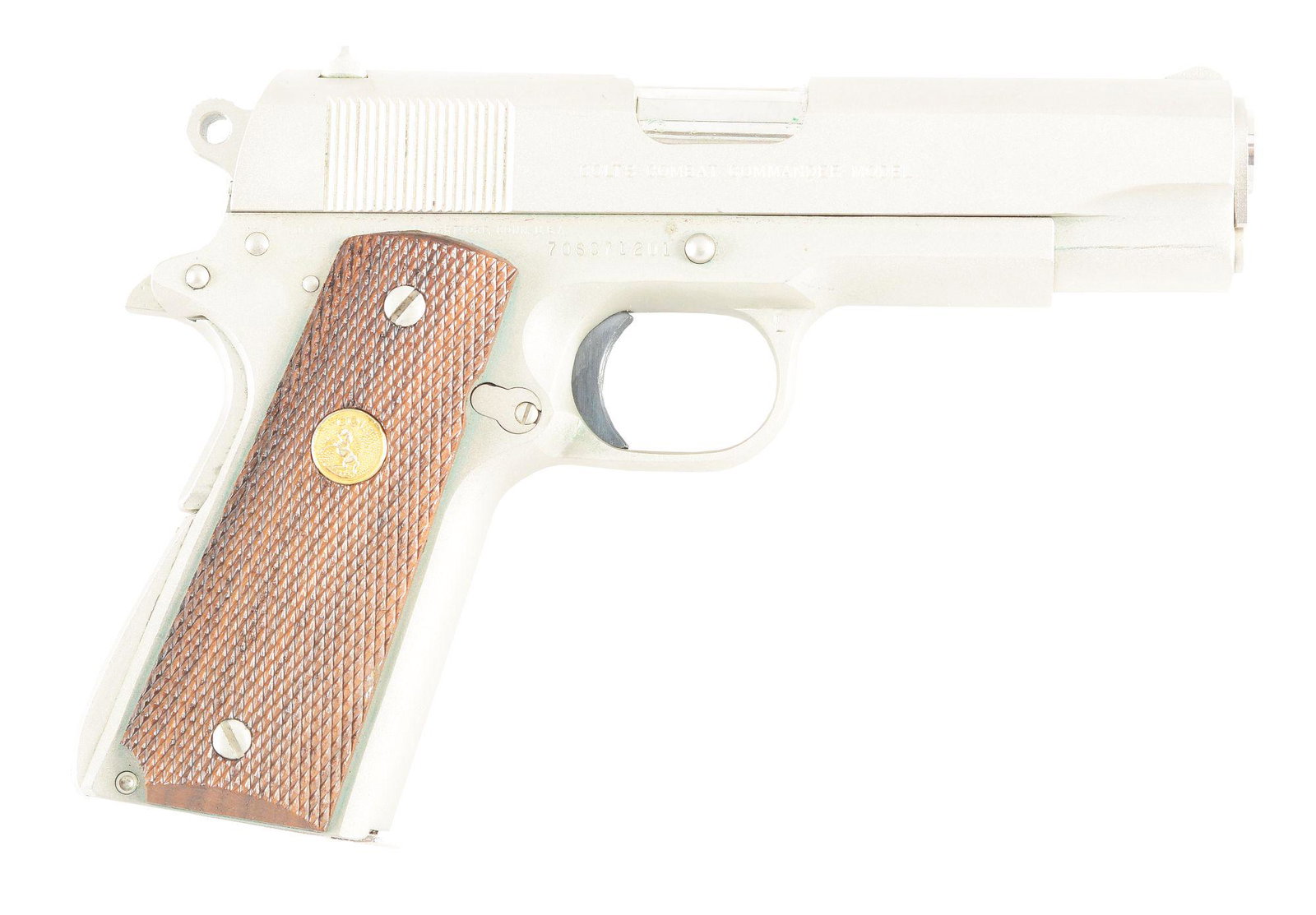 (M) COLT COMBAT COMMANDER .45 ACP SEMI-AUTOMATIC: Colt Combat Commander with matching box. Serial number dates this gun to 1979. Factory matte stainless finish with the original Colt medallion wood grips. Colt marked magazine. Serial number on gun an