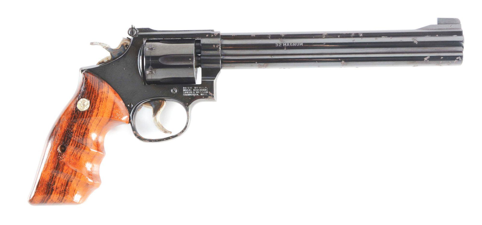 (M) SMITH AND WESSON 16-4 REVOLVER.: Full lug 8 - 3/8" barrel. Chambered in .32 magnum. K-frame, six-shot. Micro-adjustable rear sight. Blue finish. Finger groove two-piece grips with Smith and Wesson medallions. Complete with fitted Smi