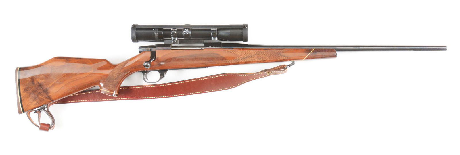 (M) WEATHERBY VANGUARD BOLT ACTION RIFLE.: Nicely figured one-piece checkered walnut stock with rosewood pistol grip cap and forearm tip. Fitted with a 3-9 variable power Zeiss Diavari-C scope. CONDITION: Like new overall. Wood shows light wea