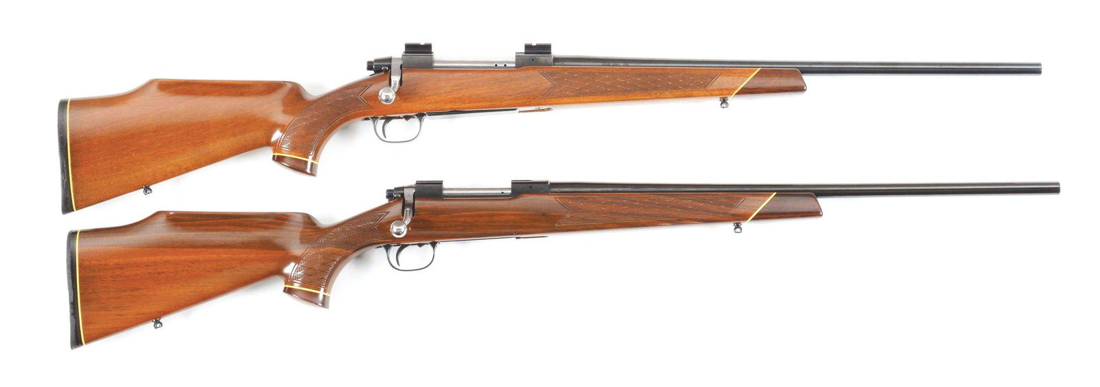 (C+M) LOT OF TWO: TWO ITHACA BOLT ACTION RIFLES.: Both rifles have one-piece walnut stocks with rosewood forearm and pistol grip caps. Pressed style checkering on wrist and forearm. High comb stock with cheek rest. Black rubber recoil pads. Rifle (A)