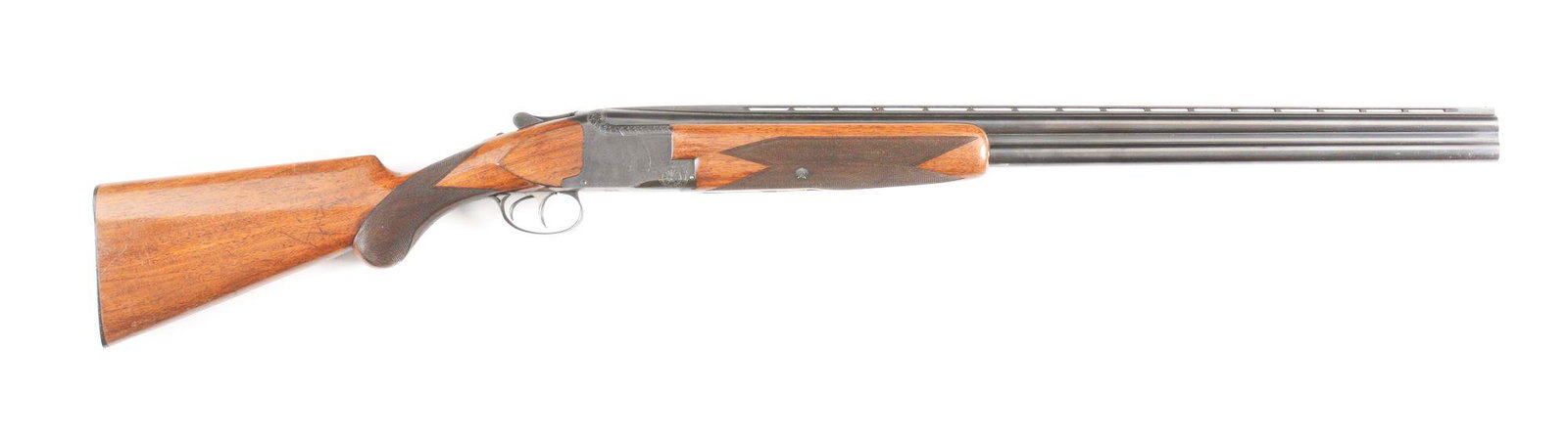 (C) BROWNING SUPERPOSED 12 GAUGE OVER/UNDER SHOTGUN.: Manufactured in 1960. Desirable double trigger configuration. Barrel has vent rib with single bead sight. Blued finish, checkered walnut stocks, round knob long tang, with Browning horn butt plate. Fr