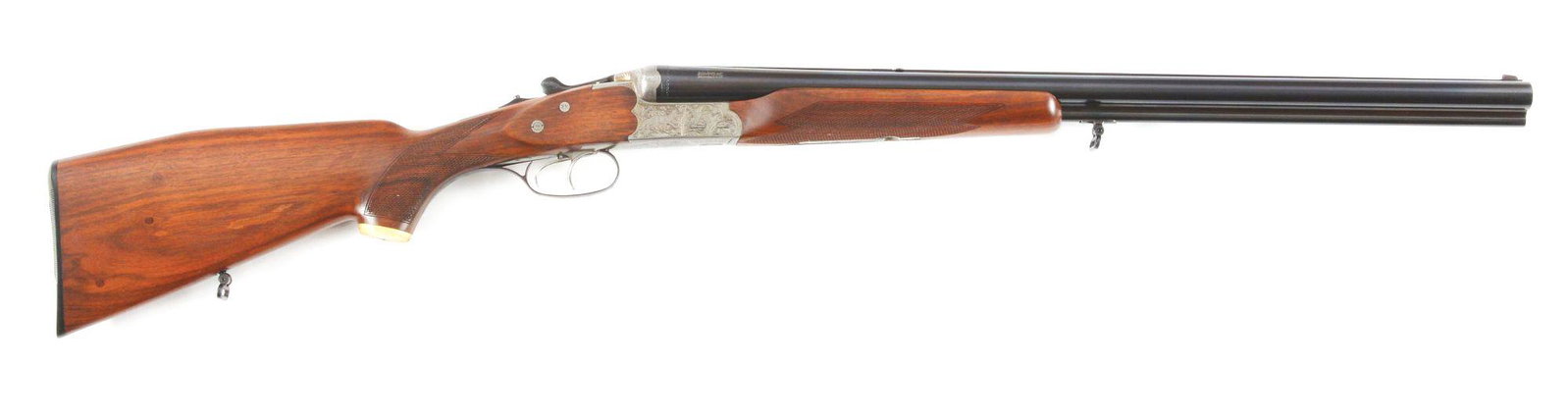 (C) J.P. SAUER 3000 DRILLING.: Made in West Germany by J.P. Sauer and Sohn and imported by Sig Arms. Gun has blued Krupp Steel barrels with rear raising sight for rifle use with a front blade sight. Game scene engraved coin finishe
