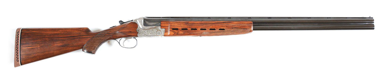(M) MERKEL 2001EL OVER UNDER 12 BORE SHOTGUN: Handsome scroll engraved Merkel boxlock. Barrels have a ventilated matted checkered rib with a white round front bead foresight. The barrels are uniquely fitted with a sharp checkered ventilated beave