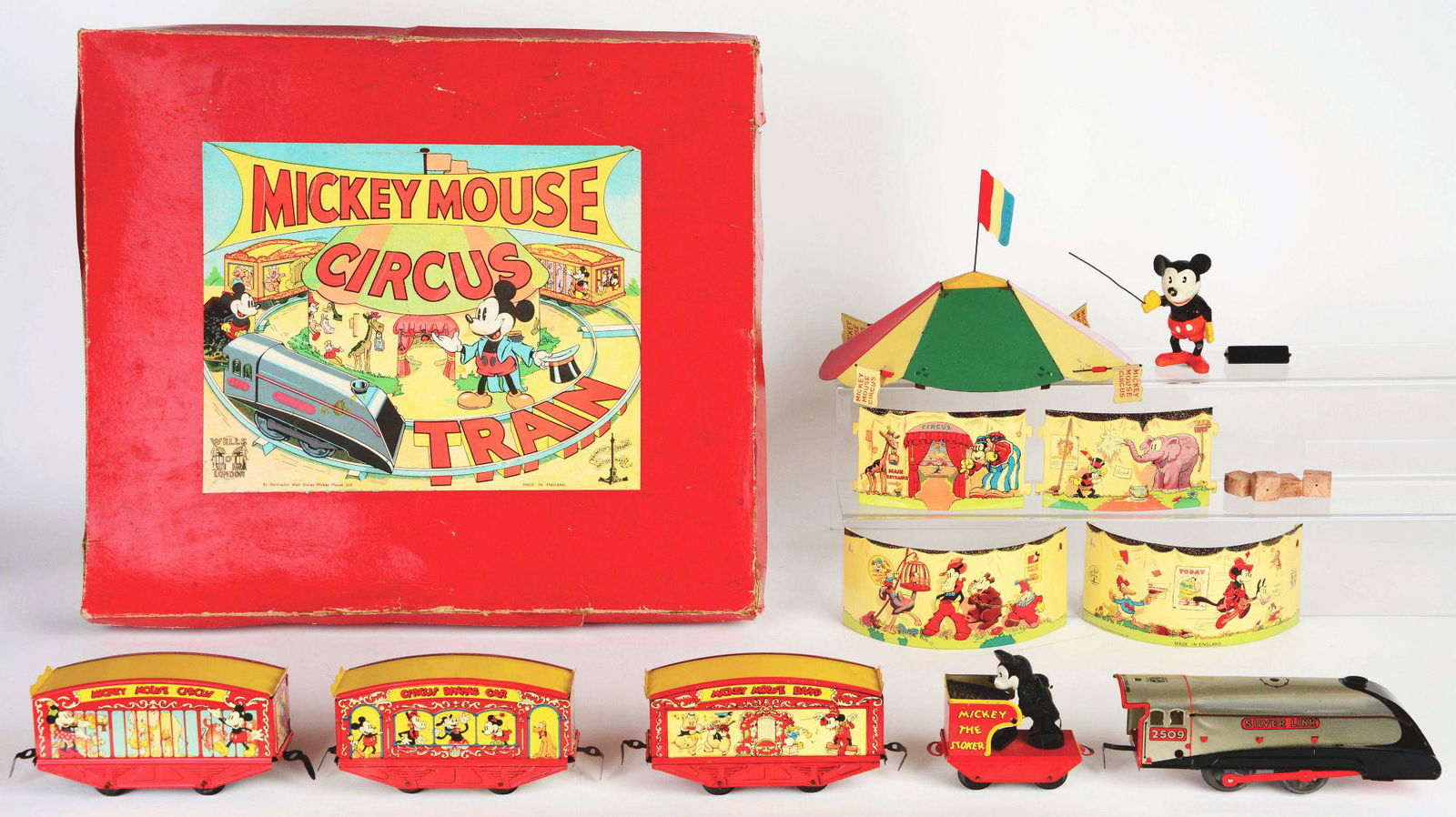 WELLS WALT DISNEY TIN-LITHO WIND-UP MICKEY MOUSE CIRCUS: Large size box and set with three circus cars. Beautiful color label on top shows Mickey Mouse holding a top hat as train is coming by. Marked "By Permission Walt Disney Mickey Mouse Ltd. Made in Engl