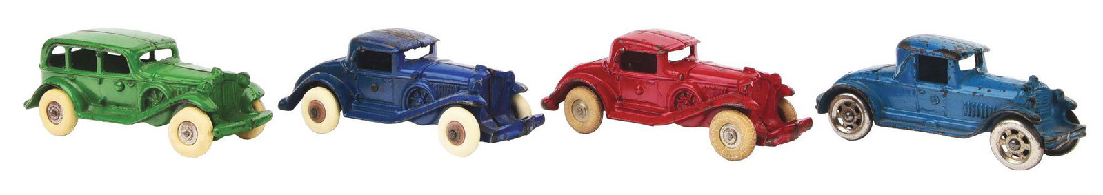 LOT OF 4: CAST-IRON WILLIAMS AUTOMOBILES.: Three nearly identical roadsters with rumble seats: one red, one light blue and one dark blue. Two have rubber tires and the third, slightly smaller, has steel spoke wheels. There is also a Cord autom