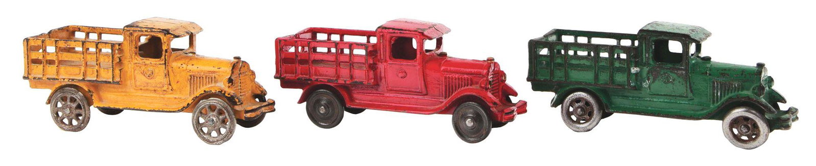 LOT OF 3: CAST-IRON A. C. WILLIAMS STAKE TRUCKS.: All are pretty much identical aside from colors and wheels. There is a red one, a green one and a mustard yellow. CONDITION: All have some general wear. Overall very good condition. Dimensions: 3" x 7