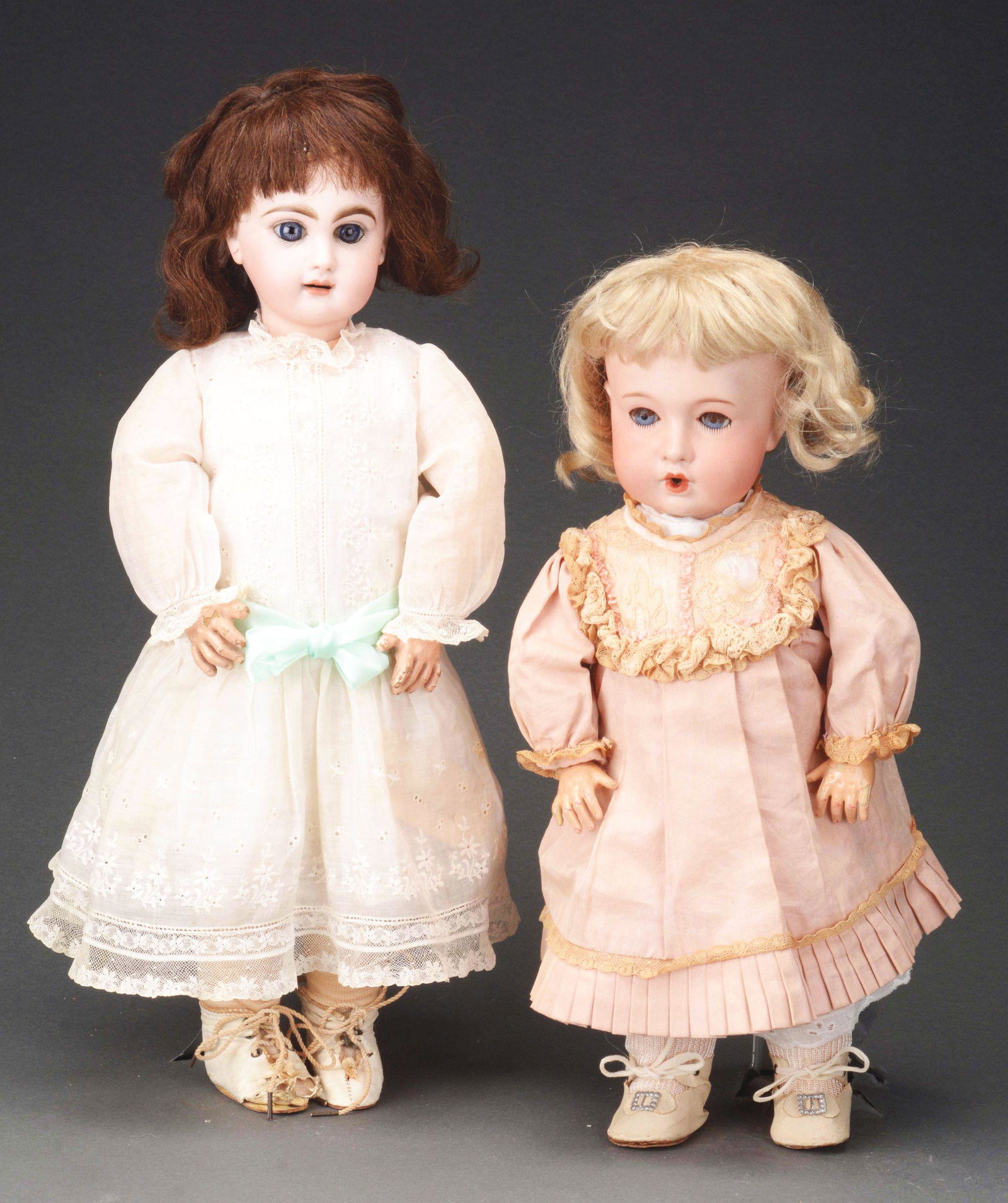 LOT OF 2: OPEN MOUTH FRENCH BISQUE DOLLS.: The slightly larger of the two, 17", is an unmarked Jumeau child with open mouth and four upper teeth, blue-grey paperweight eyes, well painted and evenly matched eyebrows, tiny eyelashes and head unm