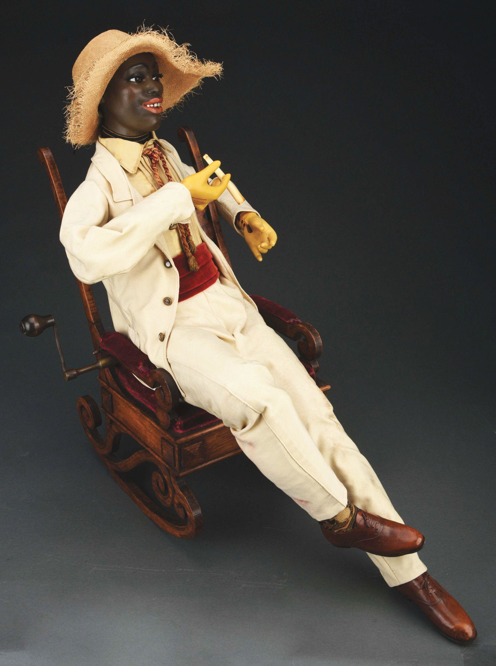 MUSICAL AUTOMATON BY GUSTAV VICHY BLACK MAN WITH: This very elaborate and large French automaton is known in French as "Negre De La Louisane". The seated figure sits reclining in a rocking chair in which much of the mechanism and music box is contain