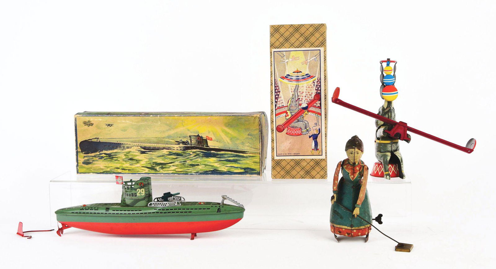 LOT OF 3: GERMAN PRE AND POST-WAR TIN-LITHO WIND-UP: Two with original boxes. One is a No. 29 Submarine with nice colorful box showing submarine in battle in ocean setting. Comes with original Nazi emblem flag. Second item is a pre-war Busy Lizzy, unmar