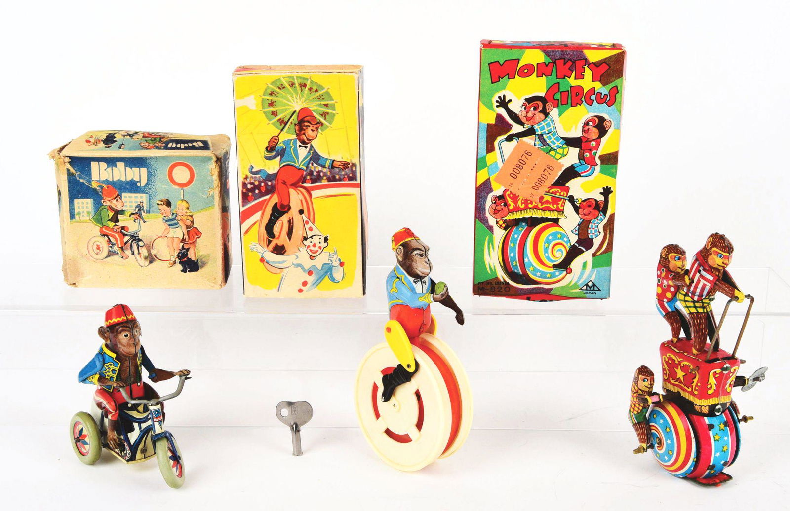 LOT OF 3: GERMAN AND JAPANESE TIN-LITHO MONKEY THEMED: One is a Japanese monkey circus. Very colorful original box shows four monkeys riding on vehicle. Second is an Arnold Boby monkey cyclist, marked "Made in U.S Zone Germany". Last is a circus monkey pa