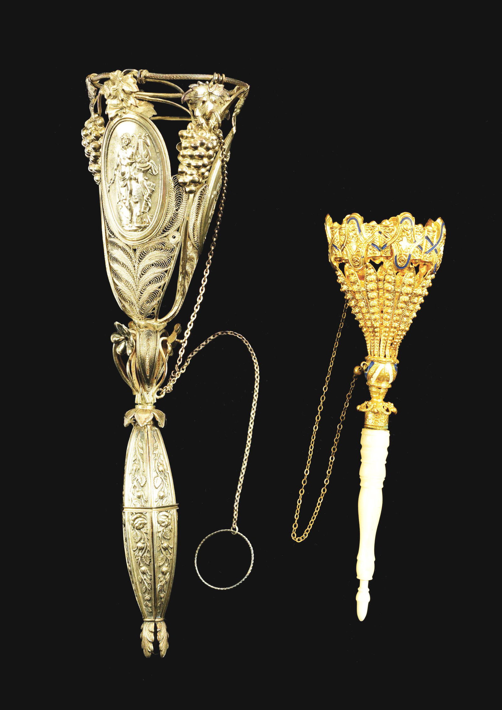 LOT OF 2: VICTORIAN POSEY HOLDERS.: The first is a silver tripod posey with three medallions of lady playing harp, grapes and floral design. 7 - 1/4" tall. No damage or repairs. The second is gold gilt with a mother of pearl handle with