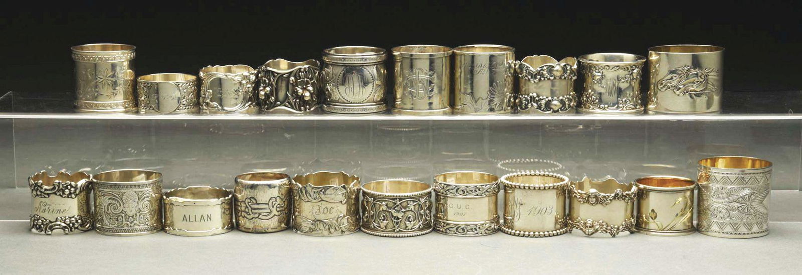 LOT OF 21: STERLING SILVER NAPKIN RINGS.: c. 1890 - 1910. Lot includes a Sensen, one with birds, one with orchids, a Shiebler, an 1845 French, a 1915 Russian with horses, another Russian, a Shreve, a Tiffany, a 1903 Wood & Hughes, a Mausen, t