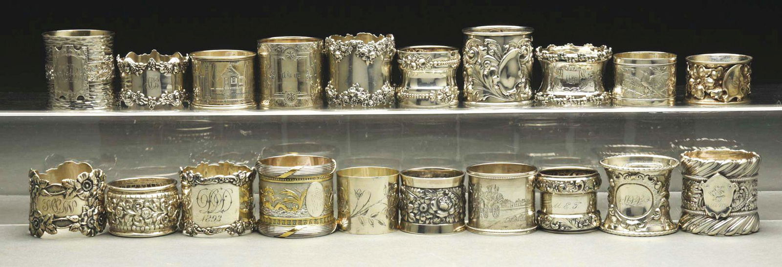 LOT OF 20: STERLING SILVER NAPKIN RINGS.: c. 1880 - 1910. Lot includes a 1910 Shreve, an 1895 Russian, an 1895 Gorham, a 1900 Swedish, a 1899 Shreve, an Unger, two Gorham, a child's Gorham, two matching Gorham, a Gorham with horses, a Reddan,