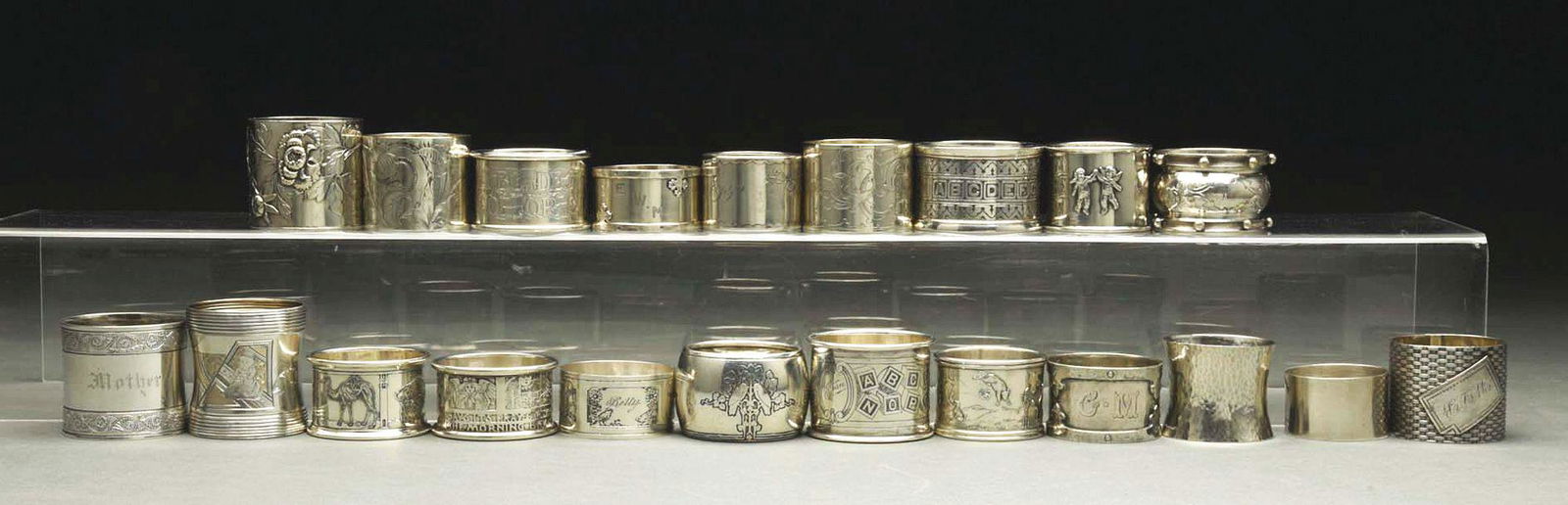 LOT OF 20: STERLING SILVER NAPKIN RINGS.: c. 1890 - 1920. Lot of sterling silver napkin rings includes a child's Tiffany, a child's alphabet Kerr, a child's Hartford, a child's animal, a child's Jack and Jill, a Wallace, five coin, a John Bel