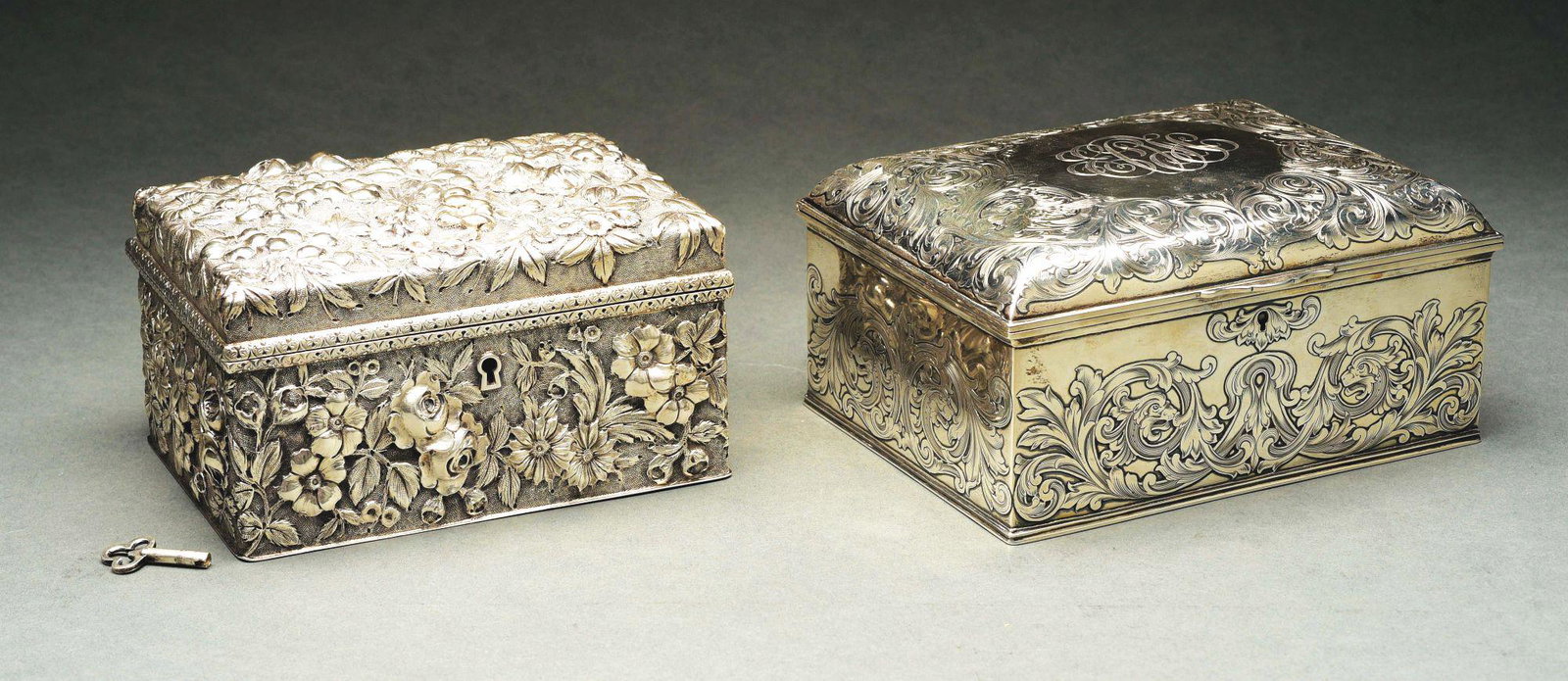 TWO AMERICAN STERLING JEWELRY BOXES.: The first Jacobi & Jenkins, Baltimore, rectangular, the sides and slightly domed lid chased with floral motifs on a matted ground; the second, Gorham, rectangular, the sides and domed lid flat-chased 