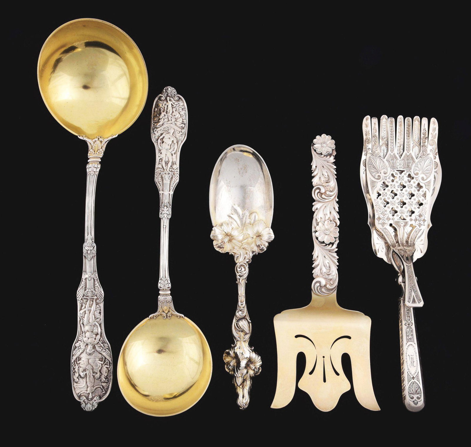 A GROUP OF AMERICAN STERLING SERVING PIECES.: Mostly late 19thC. Various makers and patterns including a pair of Gorham ladles, Mythologique pattern, both with gilt circular bowls; a Whiting serving spoon with a heavily chased floral handle; a Sh
