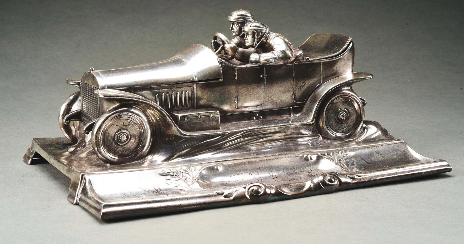 RACING CAR DESK SET SILVER PLATE.: Hood opens to reveal stamp holder and trunk opens to reveal water receptacle. Hallmarks on rear. Scratches particularly on pen tray, but otherwise no damage. Condition: Dimensions: 14 - 1/2" x 10" x 6