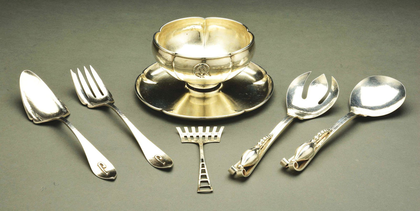 A GROUP OF AMERICAN 20TH CENTURY STERLING UTENSILS.: Including a pair of salad servers, Dunham, in Danish style with split handles applied with cast buds; another pair, Kalo, with tapering pointed handles with applied initial, model number G44; a Kalo c