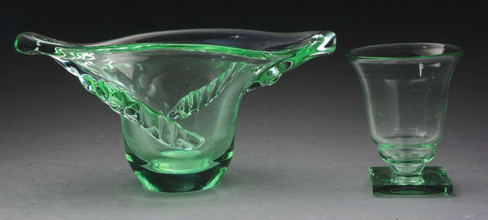 TWO DAUM GLASS VASES.: Lot consists of a large glass vase with pulled ends and heavy applied decoration running from each end across the body. The vase is done in transparent green glass and is inscribed on the underside "L
