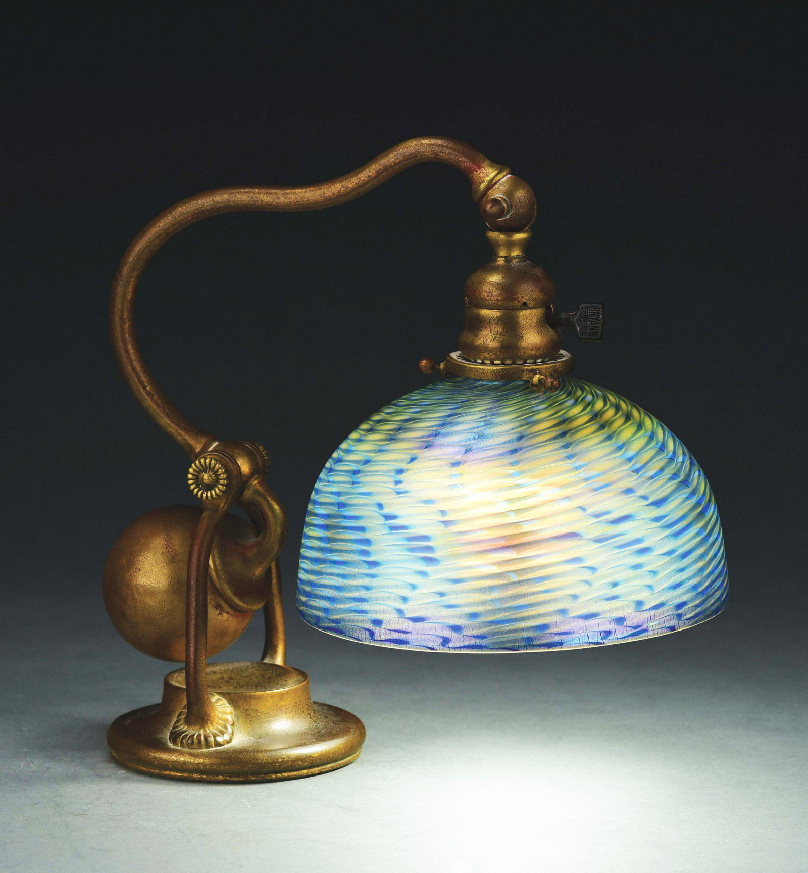 TIFFANY STUDIOS COUNTERBALANCE DESK LAMP WITH DAMASCENE: c. Early 1900's. Patinated bronze base with blue Favrile 8" glass shade. Shade is signed "L. C. T. Favrile". The shade is original to the Base. Beautiful condition. Condition: (Near Mint). Dimensions: