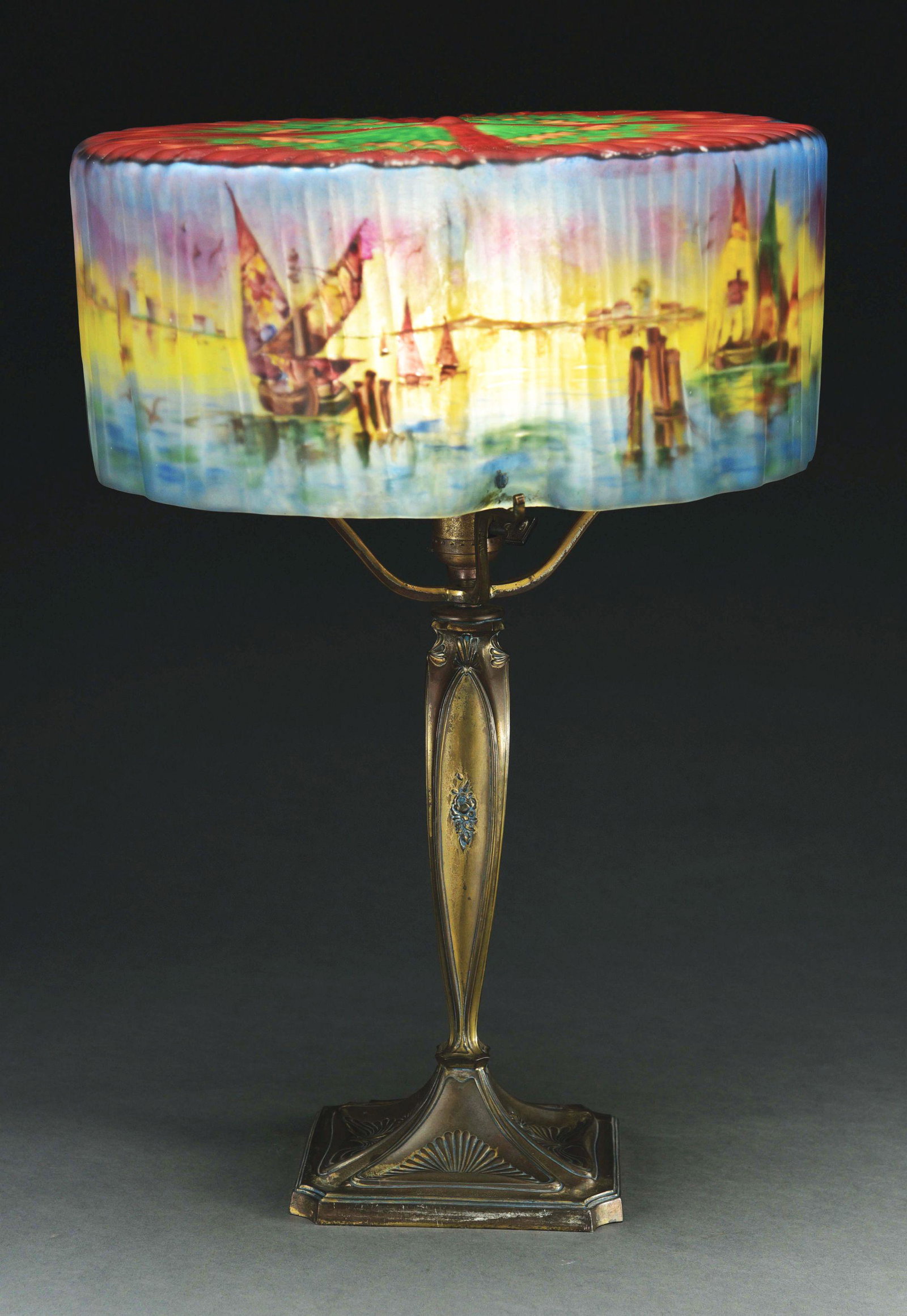 PAIRPOINT PUFFY VENETIAN HARBOR SCENE TABLE LAMP.: Fancy Chesterfield style shade. Has a ribbed exterior, reverse painted with a vibrant and bold panoramic Venetian harbor scene around the border. The top surface has a three-color geometric pattern on