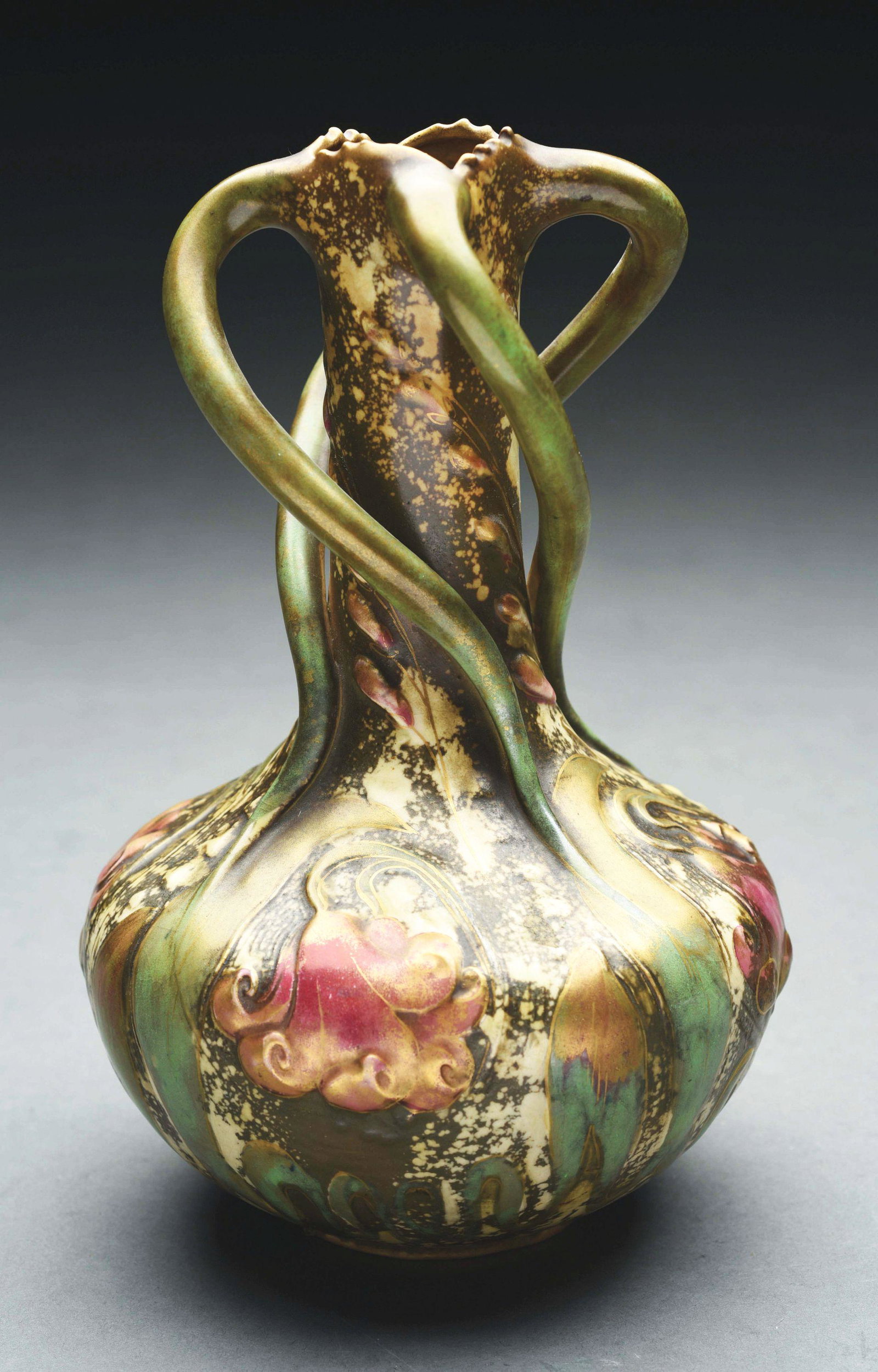 AMPHORA FLORAL VASE WITH HANDLES.: Raised flowers and four applied twisted stem handles. Oval Austria mark, Oval Amphora mark, impressed "8765-55". 9 - 1/4" high. Circa 1901. Rare form. Condition: (Mint). Dimensions: 9 - 1/4" T x 5 - 3