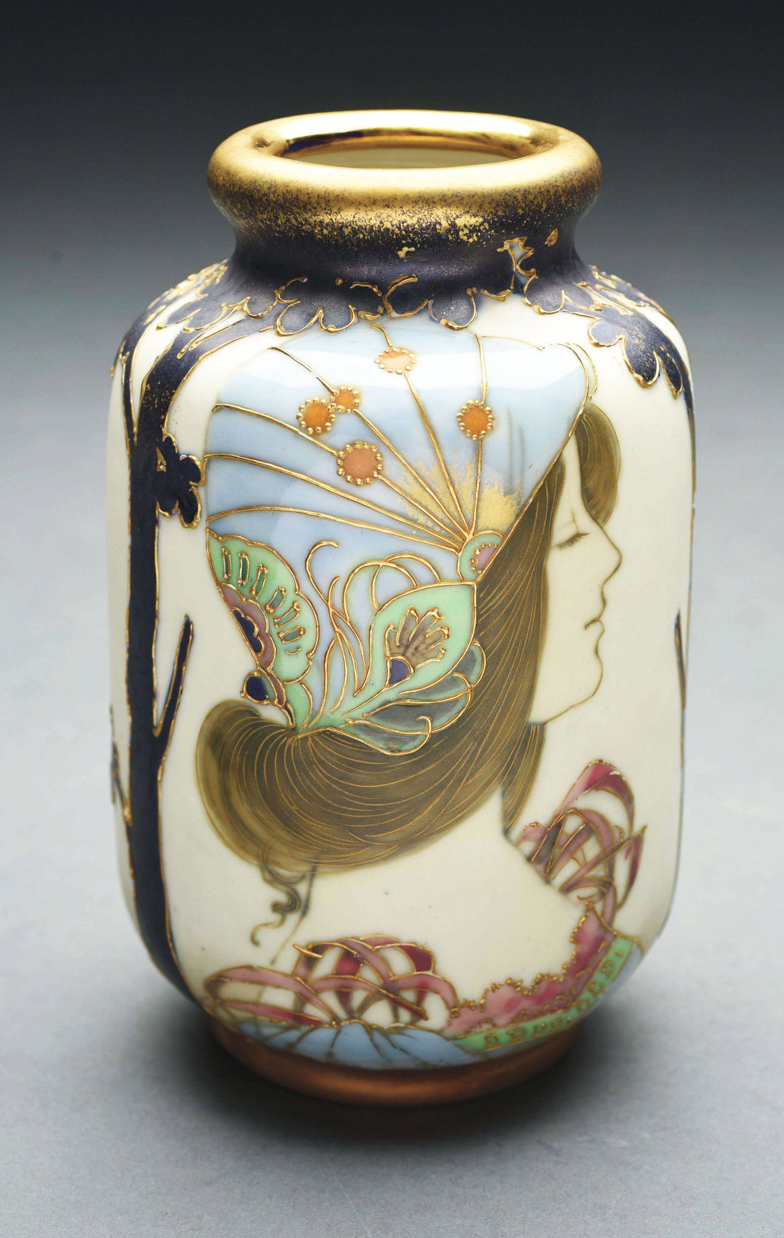 AMPHORA PORTRAIT VASE.: Matte and enamel glazes, with a young woman wearing a colorful decorated headdress. Amphora Oval mark, RSTK mark. 6 - 1/2" high. Circa 1897. Condition: (Mint). Dimensions: 6 - 1/2" T x 4" D.