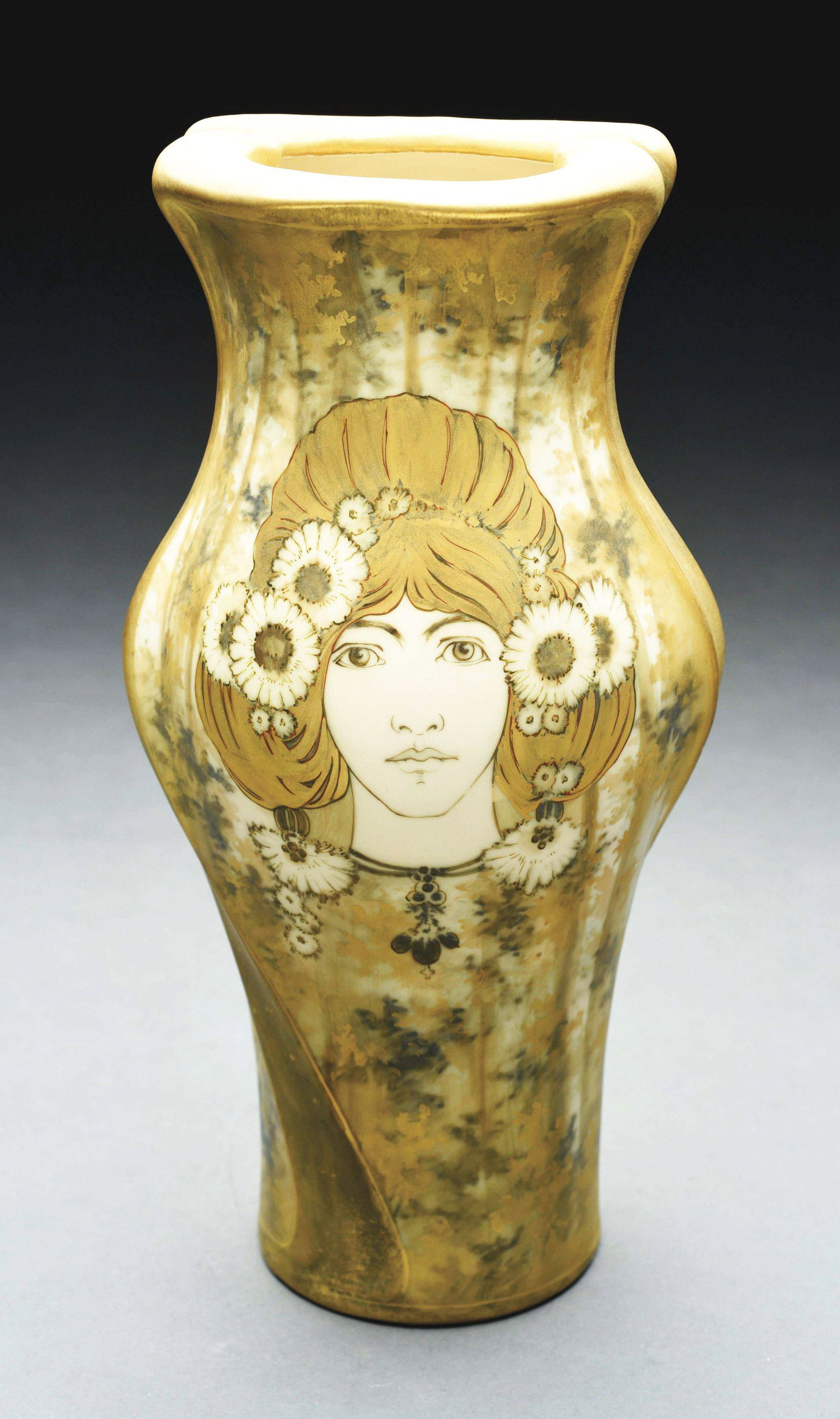 AMPHORA PORTRAIT VASE.: Tall full face portrait of a woman with daises in her hair on a forest background. Matte glazes. RSTK mark, Amphora Oval mark, Amphora Turn mark, impressed "571-5". 14 - 1/4" high. Illustrated in "Mon