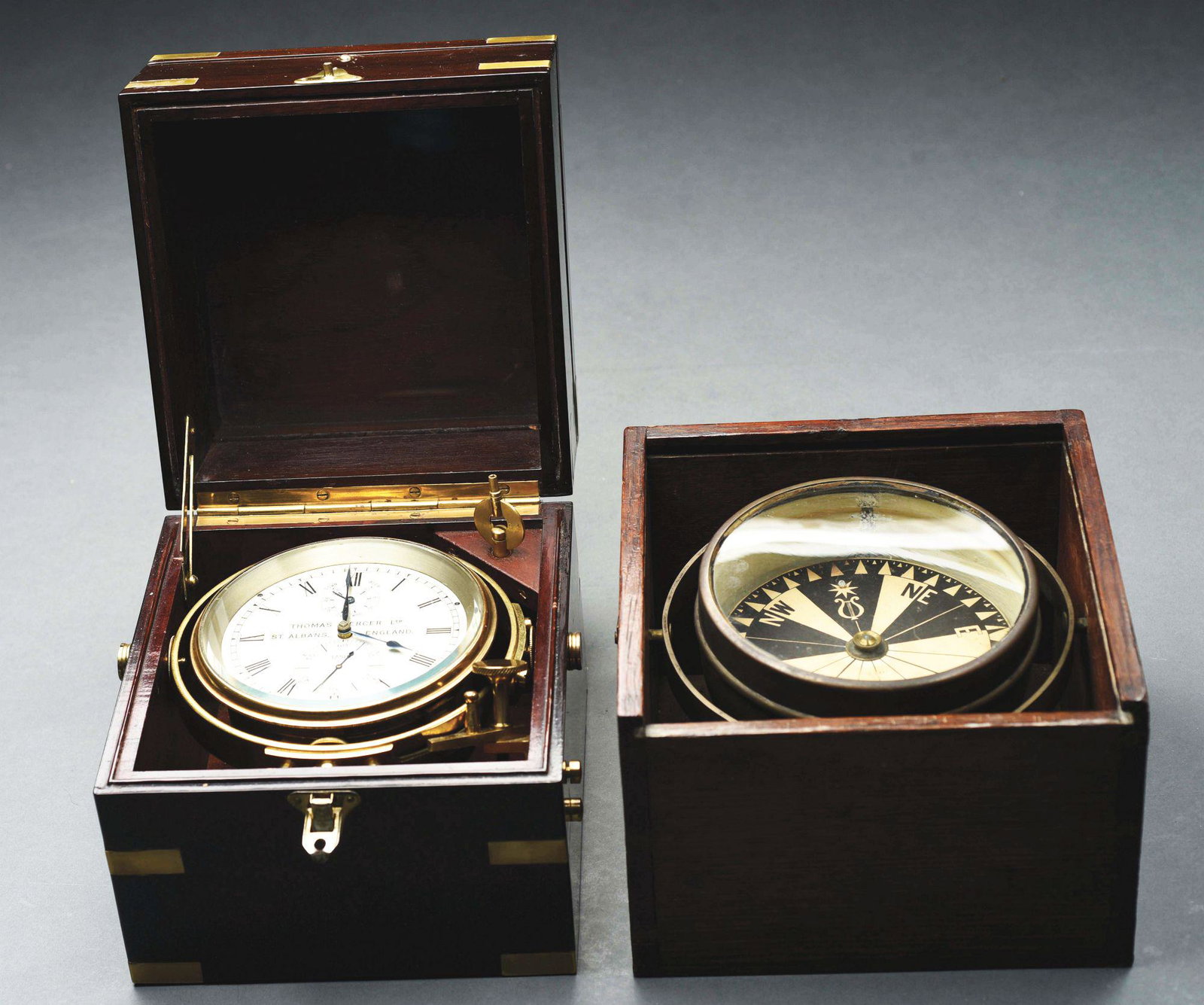 LOT OF 2: THOMAS MERCER CLOCK & WILMINGTON COMPASS.: The Thomas Mercer clock is a naval clock in working condition and comes in original case. The Wilmington compass is signed on the dial, in working condition and also comes in original case. Condition:
