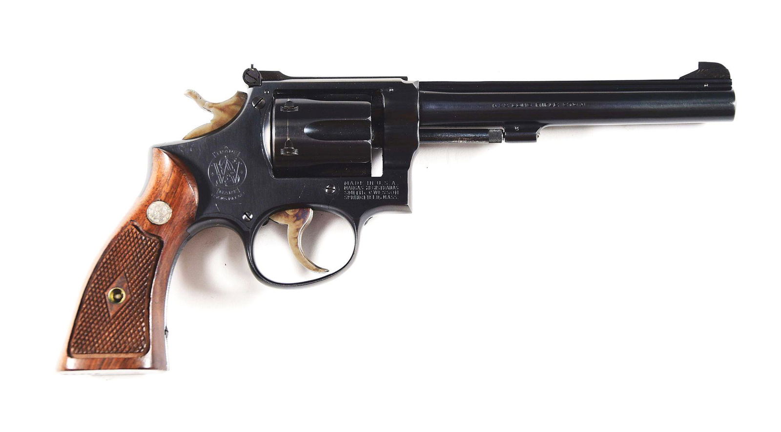 (C) SMITH & WESSON K-22 MASTERPIECE TARGET DOUBLE: Manufactured 1948,Smith & Wesson Model K-22 Masterpiece with 6 inch barrel with blue finish and diamond checkered service grips with S&W medallions. Case colored grooved trigger and checkered hammer.