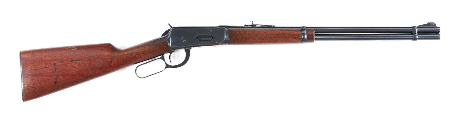 (C) WINCHESTER MODEL 1894 LEVER ACTION CARBINE IN: Winchester Model 94 lever action carbine made in 1952. Blued barrel with original adjustable rear sight and ramped front (missing hood). Blued action with plain trigger. Full magazine. Walnut plain wo