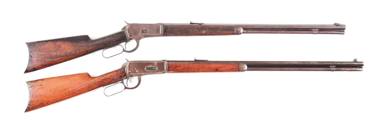 (C) LOT OF 2: WINCHESTER 1892 AND 1894 LEVER ACTION: Lot consists of (A) Winchester Model 1892 rifle. 24" octagon barrel with full length magazine. Blue, with plain straight grain walnut stock and forearm. Rifle style crescent buttplate. Chambered in .2