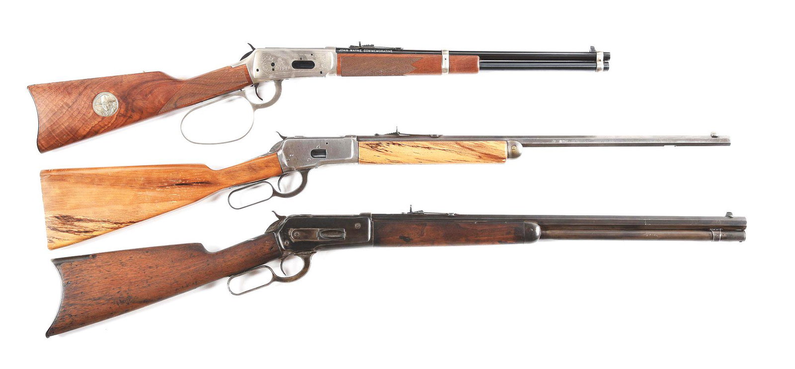 (C+A) LOT OF THREE WINCHESTER LEVER ACTION RIFLES: Lot consists of: (A) Winchester Model 94 John Wayne Commemorative lever action carbine with leather scabbard. Made in the early 1980s to commemorate the famous actor. Round steel barrel with a traditi