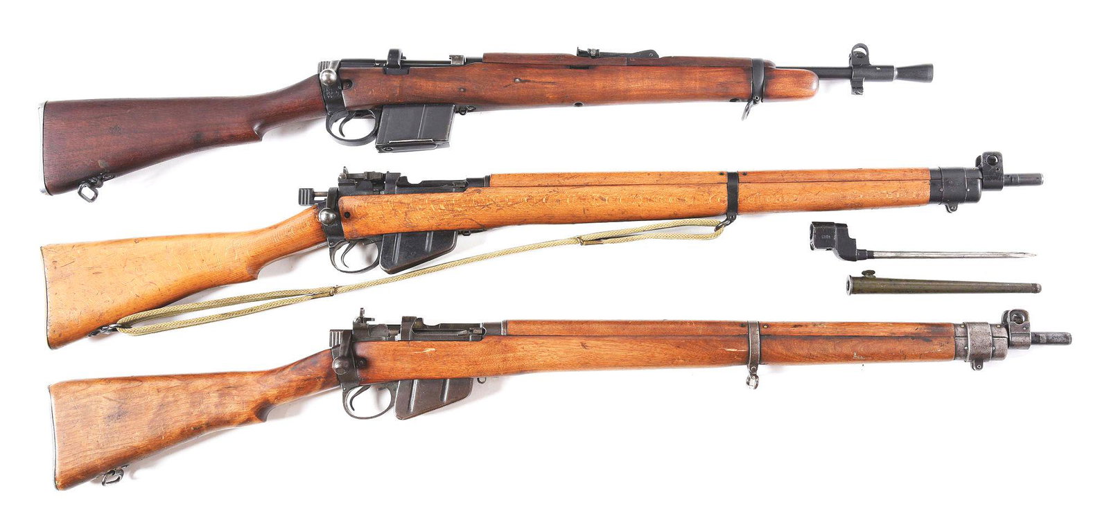 (C) LOT OF THREE: BRITISH 2A1, NO. 4 MK I/2, & NO. 4 MK: Lot consists of a 2A1, No. 4 MK I/2, and No. 4 MK I British bolt action rifles. (A) Model 2A1 manufactured in 1967 by Rifle Factory Ishapore. Right side of the barrel is import stamped "N.A. RDGFLD NJ