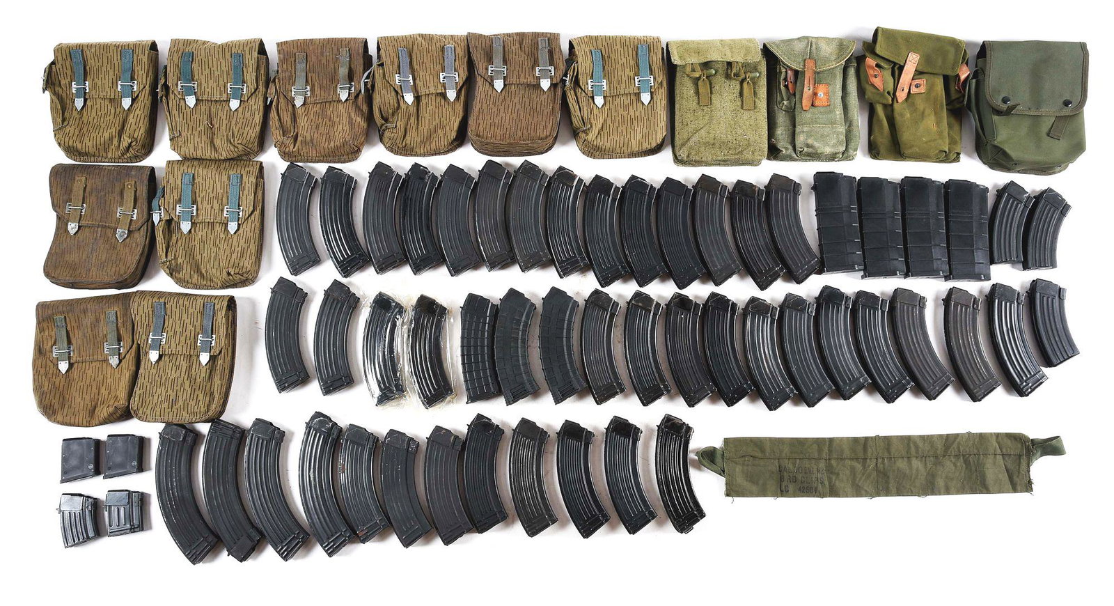 LARGE LOT OF AK MAGAZINES AND POUCHES.: Lot consists of: Ten East German four cell magazine pouches and four other various AK-47 magazine pouches. Magazines are as follows: one Chinese five round magazine, one Hungarian AK-47 five round mag